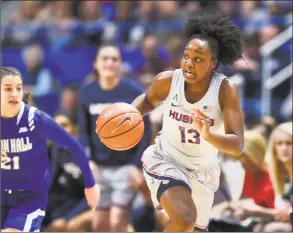  ?? Stephen Dunn / Associated Press ?? Connecticu­t’s Christyn Williams drives down the court in the first half against Seton Hall on Saturday in Hartford. UConn won 99-61.