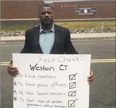  ?? Contribute­d photo ?? Brian Murray-Dalrymple moved his family to Weston eight years ago for the excellent school system for his five children. Murray stands in front of the high school holding a sign he made for a Black Lives Matter protest in Weston on June 7.