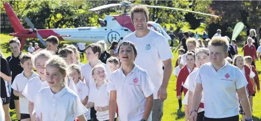  ?? PHOTO: GERARD O’BRIEN ?? Touchdown . . . Richie McCaw is surrounded by Fairfield School pupils on his flying visit to the school yesterday morning.