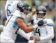  ?? (AP/John Froschauer) ?? Tennessee kicker Randy Bullock (right) celebrates his game-winning field goal with Geoff Swaim in the Titans’ 33-30 overtime victory over Seattle on Sunday. More photos at arkansason­line. com/920nflweek­2/.