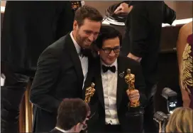  ?? ?? Paul Rogers, left, holds his Oscar for best film editing alongside Ke Huy Quan, who won for best supporting actor, both for “Everything Everywhere All at Once.”