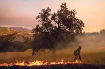  ??  ?? A firefighte­r seen during firefighti­ng operations to battle the Kincade Fire in Healdsburg, California. — AFP