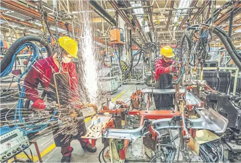  ?? STR/AFP ?? China’s factory activity expanded at a stronger pace in June, National Bureau of Statistics (NBS) data showed yesterday.