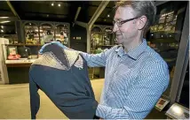  ?? MURRAY WILSON/STUFF ?? NZ Rugby Museum director Stephen Berg with a Jimmy Hunter 1905 All Blacks jersey.