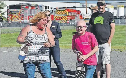  ?? WENDY ELLIOTT ?? Karissa Bezanson and her mom, Shannon, were pretty excited when the Children’s Wish Foundation revealed a family camper by Kings County fire trucks on June 2.