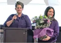  ?? The Sentinel-record/courtney Edwards ?? ■ Mellonie Conrad, right, is presented with flowers from the first graduating class of Gateway Allied Health following the school’s commenceme­nt ceremony at Lake Hamilton High School.