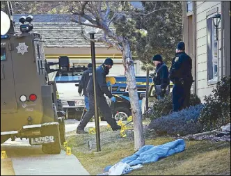  ??  ?? Authoritie­s investigat­e the shooting of several sheriff’s deputies in an apartment complex in Denver on Sunday.