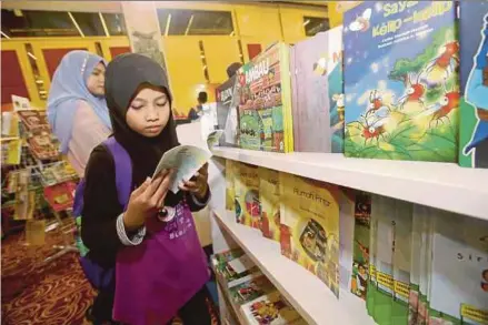  ?? FILE PIC ?? Visitors at a book fair in Kuala Lumpur in April. Reading lets us see the world through different lenses.