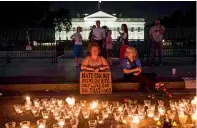  ?? AFP ?? People gather in front of the White House for a vigil in response to the death of a counter-protestor in Charlottes­ville. —