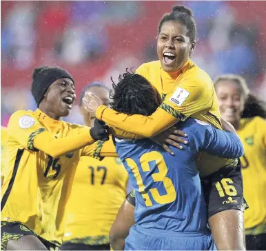  ?? FILE ?? Dominique Bond-Flasza (16), who scored the winning penalty kick, celebrates with goalkeeper Nicole McClure (13), who made two saves, as Jamaica defeated Panama 4-2 in a penalty shoot-out at the Concacaf Women’s Championsh­ips third-place play-off in Frisco, Texas to book a spot in the 2019 FIFA Women’s World Cup.