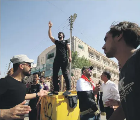  ?? Reuters ?? Protesters demanding jobs and better state services shout slogans in front of a Basra provincial council building yesterday