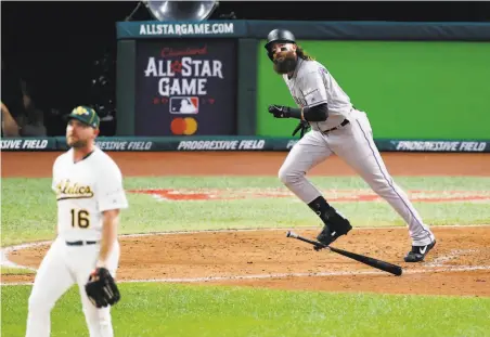  ?? Kirk Irwin / Getty Images ?? Charlie Blackmon of the Rockies hits a solo home run off the A’s Liam Hendriks to cut the AL’s lead to 21 in the sixth inning.