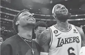  ?? GARY A. VASQUEZ/ USA TODAY SPORTS ?? LeBron James celebrates with his son Bronny after breaking the all-time scoring record last month in Los Angeles.