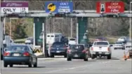  ?? AP PHOTO/MEL EVANS ?? Cars pass through the toll booths at the Garden State Parkway’s Asbury toll plaza near Tinton Falls, N.J.