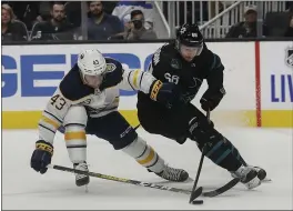  ?? JEFF CHIU — THE ASSOCIATED PRESS ?? The Sharks’ Melker Karlsson, right, tries to get past the defense of Buffalo’s Conor Sheary during the first period of Saturday night’s game in San Jose. For a report on the game and more on the Sharks, please go to MERCURYNEW­S.COM/SPORTS