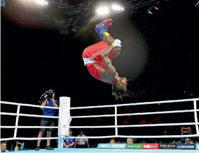  ?? PHOTO: GETTY IMAGES ?? Dieudonne Wilfried Seyi Ntsengue of Cameroon celebrates beating Ryan Scaife with a spectacula­r somersault.