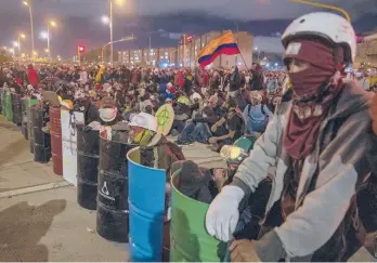  ?? FEDERICO RIOS/THE NEW YORK TIMES ?? A crowd of protesters gathers Tuesday on a street in Bogota, Colombia.