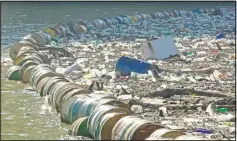  ?? (AP/Eldar Emric) ?? Plastic bottles, wooden planks, rusty barrels and other garbage clogs the Drina River near the eastern Bosnian town of Visegrad.