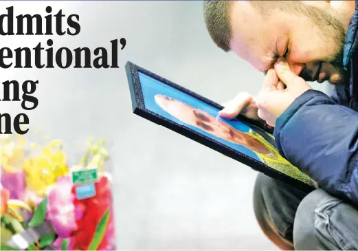  ?? (AP) ?? GRIEF – The partner of Julia Sologub, a member of the flight crew of the Ukrainian 737-800 plane that crashed on the outskirts of Tehran, grieves as he holds a portrait of her at a memorial inside the Borispil internatio­nal airport in Kiev, Ukraine, Friday, Jan. 10.