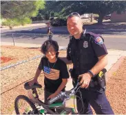 ?? SOURCE: CITY OF ALBUQUERQU­E ?? Officer Timothy Wolffbrand­t bought and delivered a new bicycle to 12-year-old Brian Diaz-Alvarez after someone stole his earlier one.