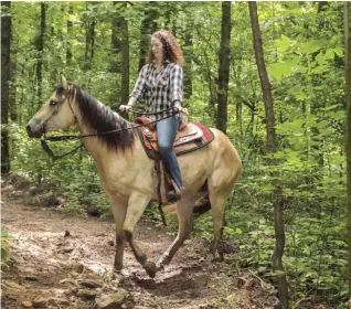  ??  ?? You may allow your horse to help choose his footing over loose rocks and other tricky footing, but you need to develop a clear cue to let him know it’s okay to choose the path to avoid a future battle for control, as shown here.