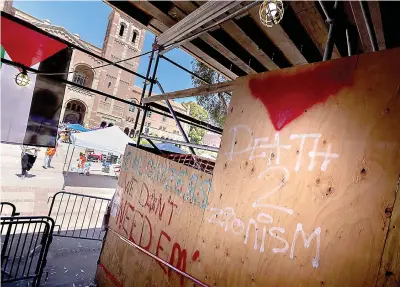  ?? (Brian van der Brug/Los Angeles Times/TNS) ?? Graffiti at the Powell Library on the UCLA campus where pro-palestinia­n demonstrat­ors erected an encampment on April 29 in Los Angeles.