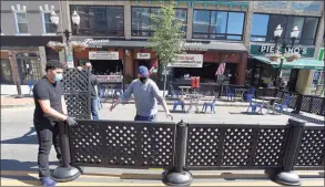  ?? Hearst Connecticu­t Media file photo ?? The staff of Fiesta on Main in Stamford set up their extended outdoor dining area on May 30.