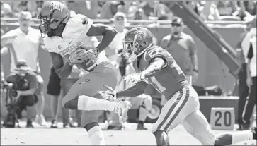  ?? Jayne Kamin-Oncea Getty Images ?? AJENE HARRIS, defending against Nevada Las Vegas wide receiver Kendal Keys here, has been a two-year starter at nickel cornerback for USC and finished his undergradu­ate work in May.