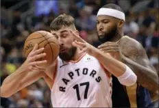  ?? NATHAN DENETTE, THE CANADIAN PRESS ?? Raptors’ Jonas Valanciuna­s is blocked by New Orleans Pelicans’ DeMarcus Cousins at Air Canada Centre on Thursday night. The Raptors won the contest, 122-118.