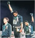  ??  ?? US sprinters Tommie Smith and John Carlos extended gloved fists in 1968