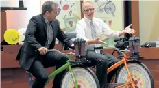  ?? DAVE JOHNSON/WELLAND TRIBUNE ?? Ward 1 Coun. Mark Carl, left, and Ward 2 Coun. David McLeod ride on blender bikes at last week's Welland city council meeting.