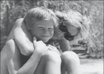  ?? THE DUKE OF CAMBRIDGE AND PRINCE CHARLES, THE ASSOCIATED PRESS ?? Photo from Diana’s personal photo album shows the princess and Prince Harry on holiday.