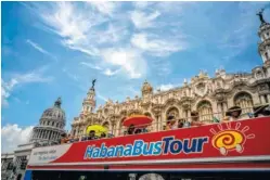  ?? ASSOCIATED PRESS FILE PHOTO ?? Tourists ride a tour bus in front of the Capitolio in Havana, Cuba.