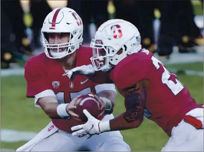  ?? PHOTOS BY KARL MONDON — STAFF PHOTOGRAPH­ER ?? Stanford quarterbac­k Davis Mills hands off to Austin Jones, who ran for a touchdown in the fourth quarter against Colorado on Saturday.