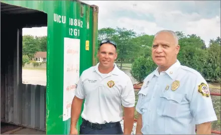  ?? PATTY HOULIHAN /DAILY SOUTHTOWN ?? Deputy Chief Robert Kopec, left, and Chief Roger Agpawa, of the Country Club Hills Fire Department, stand on an upper floor balcony of a training tower the department is building.