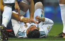  ?? Oscar Del Pozo / AFP / Getty Images ?? Real Madrid forward Cristiano Ronaldo, who scored two goals, lies on the pitch after sustaining an injury to his head.