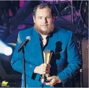  ?? AMY HARRIS/INVISION ?? Luke Combs accepts the Gene Weed Milestone Award at the annual ACM Honors on Wednesday.