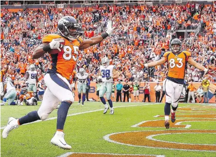  ?? MATTHEW STOCKMAN/GETTY IMAGES ?? Denver Broncos tight end Virgil Green scores a touchdown against the Dallas Cowboys in the third quarter on Sunday in Denver. Green’s TD was one of four thrown by quarterbac­k Trevor Siemian in the Broncos’ 42-17 blowout win over the Cowboys.