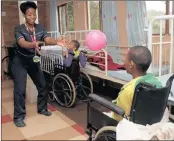  ??  ?? Nurse Slondile Zungu plays ball with one of the children.