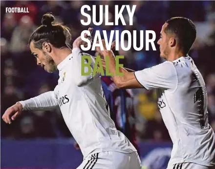  ?? AFP PIC ?? Real Madrid’s Gareth Bale (left) brushes off teammate Lucas Vazquez who tries to congratula­te him after scoring against Levante on Sunday.