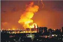  ??  ?? An explosion in Gaza City after air raids by Israeli forces early yesterday hit Hamas targets