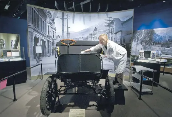  ??  ?? Conservato­r Lisa Bengston puts the finishing touches on the seats of a 1903 City and Suburban Electric Carriage, which was part of the Free Spirit: Stories of You, Me and B.C. exhibit in 2008.