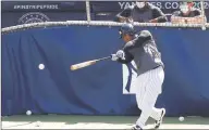  ?? Kathy Willens / Associated Press ?? With coaches looking on, New York Yankees’ Gleyber Torres bats in the cage during baseball summer training on Sunday at Yankee Stadium in New York.