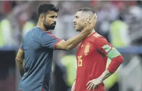  ??  ?? 0 Diego Costa consoles Spain captain Sergio Ramos after last night’s defeat.