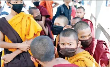  ?? AFP ?? Young Buddhist monks wearing facemasks in in Yangon, Myanmar. The country of 54 million people had been the world’s largest country by population not to report a single case of the pandemic.