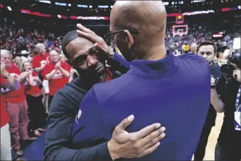  ?? GERALD HERBERT/AP ?? PHOENIX SUNS HEAD COACH MONTY WILLIAMS wipes tears from the face of New Orleans Pelicans head coach Willie Green after a first-round playoff series on Thursday in New Orleans.