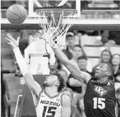  ?? L.G. PATTERSON/AP ?? Missouri’s Jordan Geist, left, goes up against UCF’s Aubrey Dawkins during the Knights’ loss on Sunday.