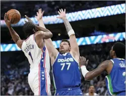  ?? TONY GUTIERREZ — THE ASSOCIATED PRESS ?? The 76ers’ James Harden, left, is forced to pass by Dallas’ Luka Doncic, center, and Kyrie Irving, right, on Thursday in Dallas.