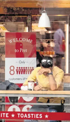  ?? PHOTO: DOMINIC LIPINSKI/PA WIRE ?? Hard times: A customer takes a break in a Pret a Manger outlet in central London yesterday.