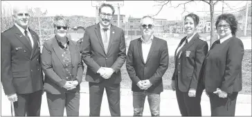  ?? GORDON LAMBIE ?? Sherbrooke Police Chief Danny Mcconnell with Public Security committee chair Danielle Berthold, Sherbrooke Mayor Steve Lussier, Bromont Mayor Louis Villeneuve, Bromont Police Inspector Sandy Robitaille, and Sherbrooke Police Captain Guylaine Perron standing in the new "neutral zone" for safe exchanges at the Sherbrooke Police headquarte­rs.